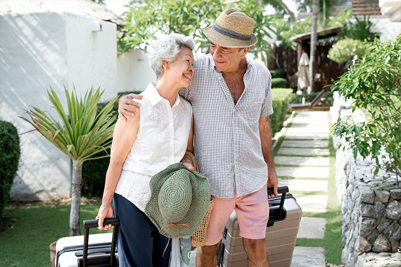 couple with their luggage on vacation reasonable rate of return during retirement three core principles martinez georgia