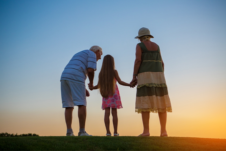 grandparents watching the sunset holding hands with their granddaughter are annuities safe martinez georgia