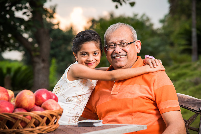 granddaughter sitting outside with her arms around her grandpa safe retirement strategies martinez ga